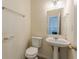 Small powder room featuring pedestal sink, updated faucet and a white toilet at 5680 Hampton Ct, Atlanta, GA 30349