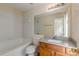 Bathroom featuring a tub, vanity, mirror, and white tile, with lots of natural light at 5680 Hampton Ct, Atlanta, GA 30349