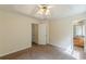 Bedroom with carpet, ceiling fan, two entrances, and view into the bathroom at 5680 Hampton Ct, Atlanta, GA 30349