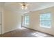 Comfortable bedroom featuring neutral walls, carpet flooring and a ceiling fan with attached lighting at 5680 Hampton Ct, Atlanta, GA 30349