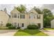 Charming two-story home with yellow siding, a well-maintained yard, and an inviting front entrance at 5680 Hampton Ct, Atlanta, GA 30349