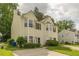 Inviting two-story home with tidy landscaping, neutral yellow siding, and classic window shutters at 5680 Hampton Ct, Atlanta, GA 30349