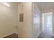 Hallway featuring a utility panel and closet leading to a well-lit bedroom at 5680 Hampton Ct, Atlanta, GA 30349