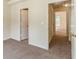 Hallway with beige carpet, neutral walls, base trim, and white doors at 5680 Hampton Ct, Atlanta, GA 30349