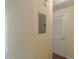 Neutral hallway featuring a utility panel and a white door at 5680 Hampton Ct, Atlanta, GA 30349