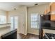 Well-lit kitchen with wooden cabinets, granite countertops, and modern appliances near the door at 5680 Hampton Ct, Atlanta, GA 30349