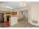 A bright kitchen has wooden cabinets, black appliances, and a breakfast bar overlooking the living area at 5680 Hampton Ct, Atlanta, GA 30349