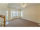 Sunlit living room with plush carpet, bay windows, and a view of the front yard at 5680 Hampton Ct, Atlanta, GA 30349