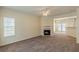 An inviting living room features a fireplace, neutral carpet, and lots of natural light at 5680 Hampton Ct, Atlanta, GA 30349