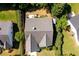 An aerial view showcases the home's roof, small patio area, landscaping, and proximity to neighboring houses at 2721 Maeve Ct, Dacula, GA 30019