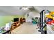A large attic space with a variety of furniture, a TV, and exercise equipment at 2721 Maeve Ct, Dacula, GA 30019
