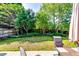 A backyard with a patio, chair, and lush green trees at 2721 Maeve Ct, Dacula, GA 30019