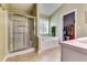 Bright bathroom features a glass enclosed shower and a large soaking tub next to a window at 2721 Maeve Ct, Dacula, GA 30019