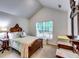 Bedroom featuring natural light, neutral paint, carpet and antique furnishings at 2721 Maeve Ct, Dacula, GA 30019