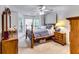 This bedroom has a ceiling fan, carpeted floors, neutral paint, and lots of natural light at 2721 Maeve Ct, Dacula, GA 30019