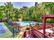 An inviting community pool surrounded by lush greenery, near the tennis courts at 2721 Maeve Ct, Dacula, GA 30019