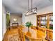 Formal dining room with hardwood floors, modern lighting, and ample space for entertaining at 2721 Maeve Ct, Dacula, GA 30019