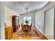 Elegant dining room with wood floors, a stylish light fixture, and plenty of seating at 2721 Maeve Ct, Dacula, GA 30019