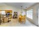 Open-concept dining area with vaulted ceiling, light fixture, and large window for natural light at 2721 Maeve Ct, Dacula, GA 30019
