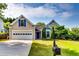 Charming home featuring a well-manicured lawn, classic architecture, and inviting curb appeal at 2721 Maeve Ct, Dacula, GA 30019