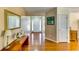 Bright foyer with hardwood floors, a decorative mirror, and a view into the home at 2721 Maeve Ct, Dacula, GA 30019