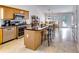 Open kitchen featuring stainless steel appliances, an island with seating, and an eat-in area at 2721 Maeve Ct, Dacula, GA 30019