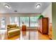 Sunlit living room featuring hardwood floors, cabinets and large windows with natural light at 2721 Maeve Ct, Dacula, GA 30019