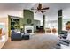 Cozy living room features a fireplace, built-in shelves, and a view to the eat-in kitchen at 2721 Maeve Ct, Dacula, GA 30019