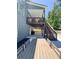 Outdoor dining area on the patio with an elevated deck with stairs and a stylishly designed backyard at 4736 Landing Water Path, Buford, GA 30519