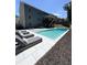 Beautiful in-ground pool with patio, lounge chairs and meticulously maintained landscaping in the backyard at 4736 Landing Water Path, Buford, GA 30519