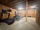 Unfinished basement features a home gym with modern exercise equipment and TV at 4736 Landing Water Path, Buford, GA 30519