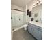 Bathroom featuring a glass-enclosed shower, gray vanity with quartz counter, and modern fixtures at 4736 Landing Water Path, Buford, GA 30519