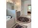 Bathroom showing bathtub, gray vanity with double sinks, and bedroom entry at 4736 Landing Water Path, Buford, GA 30519