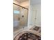 Bathroom featuring tiled shower with glass door and tiled seat at 4736 Landing Water Path, Buford, GA 30519