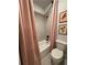 Inviting bathroom featuring a toilet, shower/tub combo, and pink curtain at 4736 Landing Water Path, Buford, GA 30519