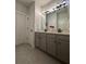 Gray vanity with double sinks, white quartz countertop, and black modern fixtures at 4736 Landing Water Path, Buford, GA 30519