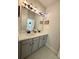 Bathroom featuring double vanity, gray cabinets, modern lighting, and tile flooring at 4736 Landing Water Path, Buford, GA 30519