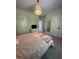 Comfortable bedroom features plush carpet, chandelier, and double closet for ample storage at 4736 Landing Water Path, Buford, GA 30519