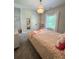 Cozy bedroom with carpet, chandelier and lots of natural light from window with sheer curtains at 4736 Landing Water Path, Buford, GA 30519