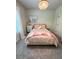 Bright bedroom with carpet, neutral walls, decorative chandelier, and a large window providing natural light at 4736 Landing Water Path, Buford, GA 30519