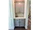 Butler's pantry with gray cabinets, quartz counters, tiled backsplash, and gold hardware at 4736 Landing Water Path, Buford, GA 30519