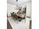 Large dining room with a long table, seating for eight, and elegant lighting at 4736 Landing Water Path, Buford, GA 30519