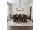 Dining area with a large table, seating for eight, and a modern chandelier at 4736 Landing Water Path, Buford, GA 30519