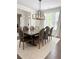 Dining area boasts a large table, seating for eight, and contemporary lighting fixtures at 4736 Landing Water Path, Buford, GA 30519