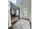 Bright foyer with dark wood floors, an area rug, study, and a clear view to the front door at 4736 Landing Water Path, Buford, GA 30519