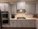 Close-up of the modern kitchen, featuring updated cabinets, stainless steel appliances, and countertops at 4736 Landing Water Path, Buford, GA 30519