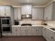 Modern kitchen showcases grey cabinets, white countertops, stainless appliances, and modern finishes for a sleek design at 4736 Landing Water Path, Buford, GA 30519