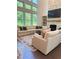 Sun-drenched living room boasts tall windows and a cozy fireplace with built-in shelves at 4736 Landing Water Path, Buford, GA 30519