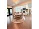 Living room features a stone fireplace, large windows, hardwood floors, and a cozy seating area at 4736 Landing Water Path, Buford, GA 30519