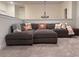 Cozy living room featuring a large sectional sofa, plush carpet, and stylish decor at 4736 Landing Water Path, Buford, GA 30519